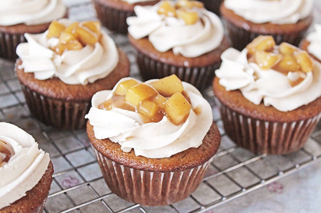 spiced fireball cupcakes with frosting and sauteed apples on top