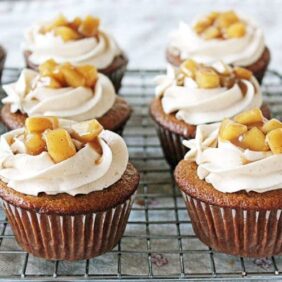 fireball cupcakes topped with icing and sauteed apples; cupcakes on wire cooling rack