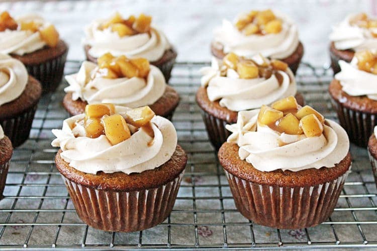 fireball cupcakes topped with icing and sauteed apples; cupcakes on wire cooling rack