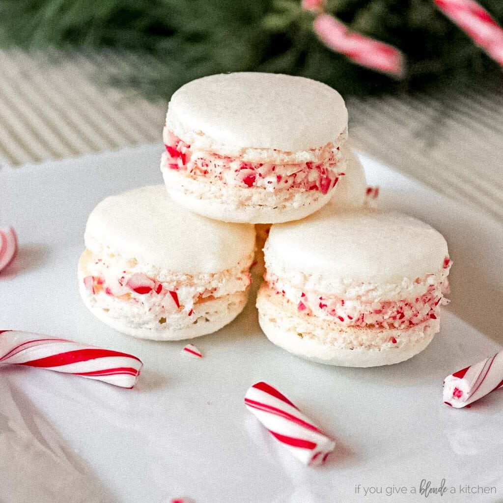 peppermint macarons with candy canes on white plate