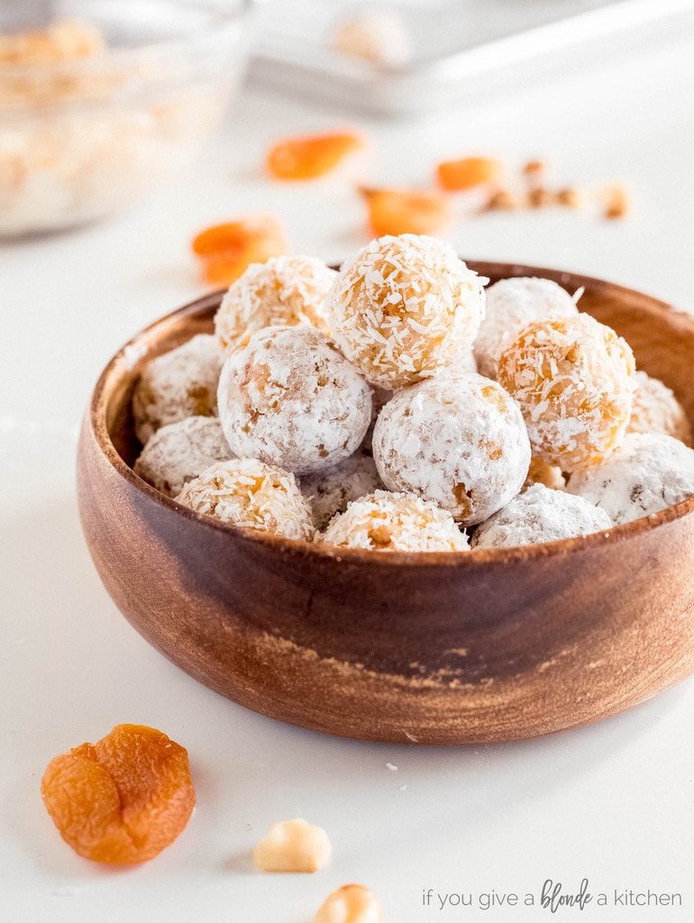 coconut apricot balls in wooden bowl