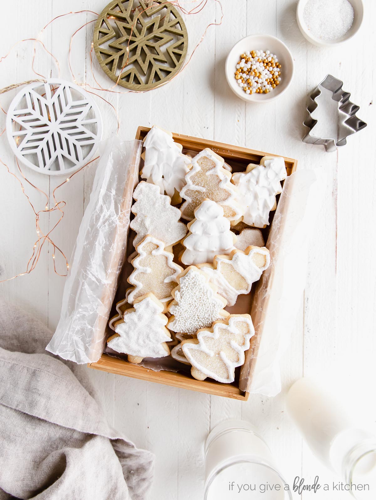 iced christmas tree cut out sugar cookies in a wood box