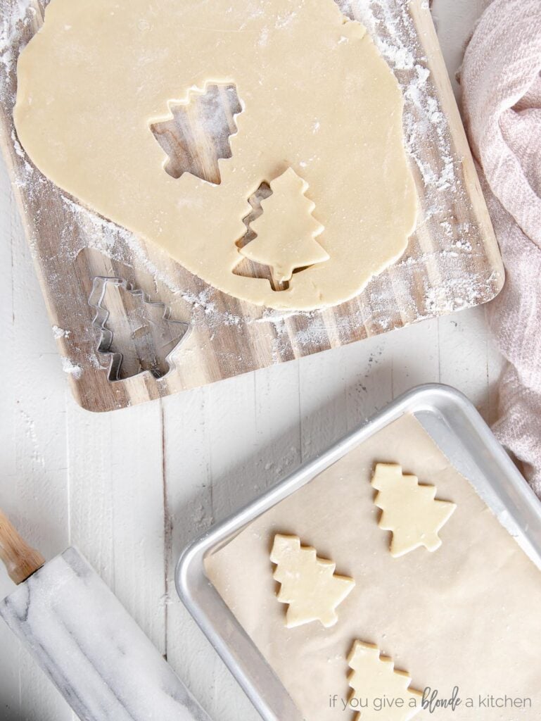 no chill cut out sugar cookie dough rolled out with christmas tree cut outs of dough