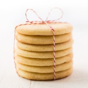 Easy cut out sugar cookie recipe stack of cookies tied in red baker's twine