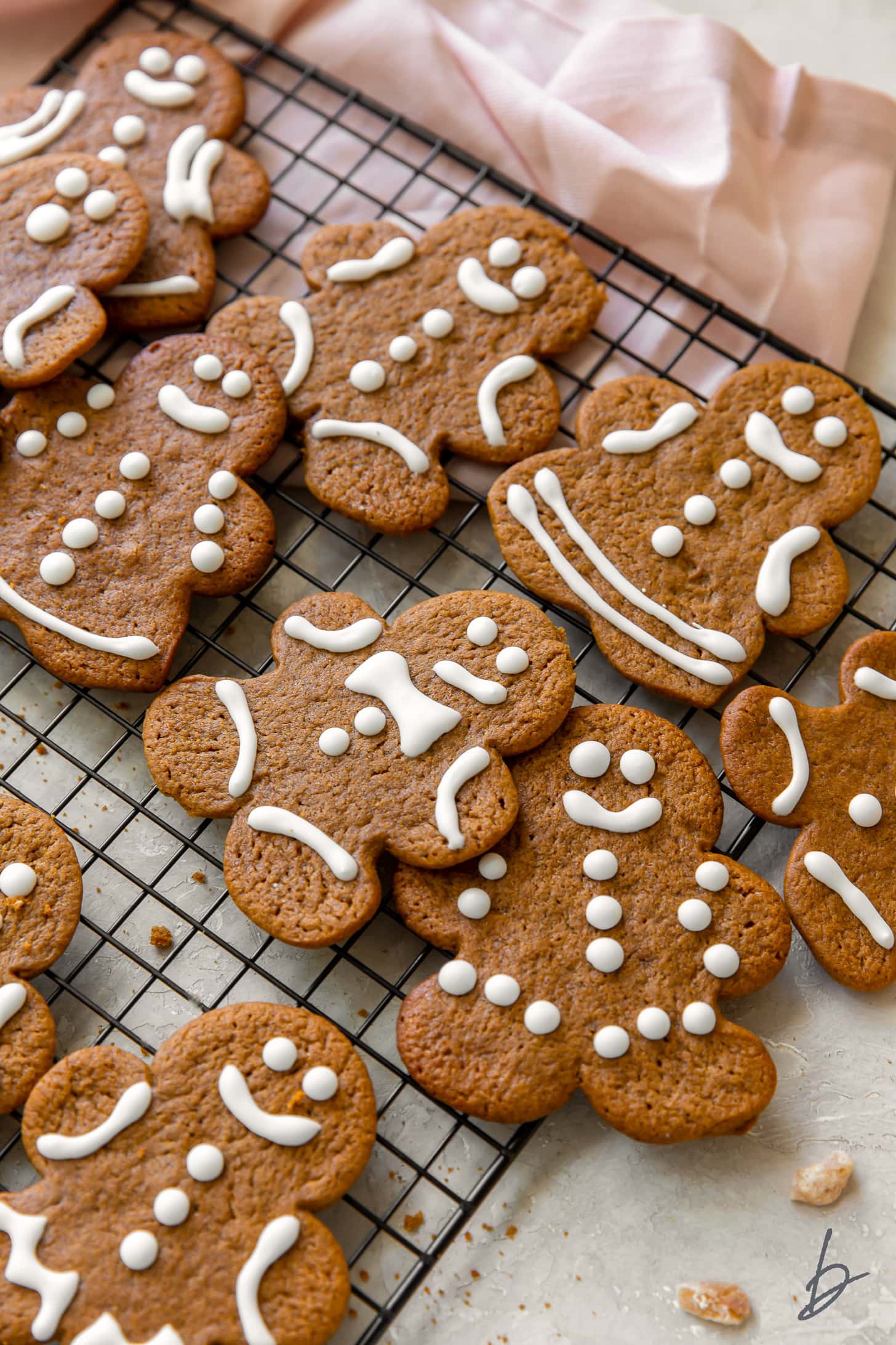 gingerbread man cookies decorated with royal icing on wire cooling rack