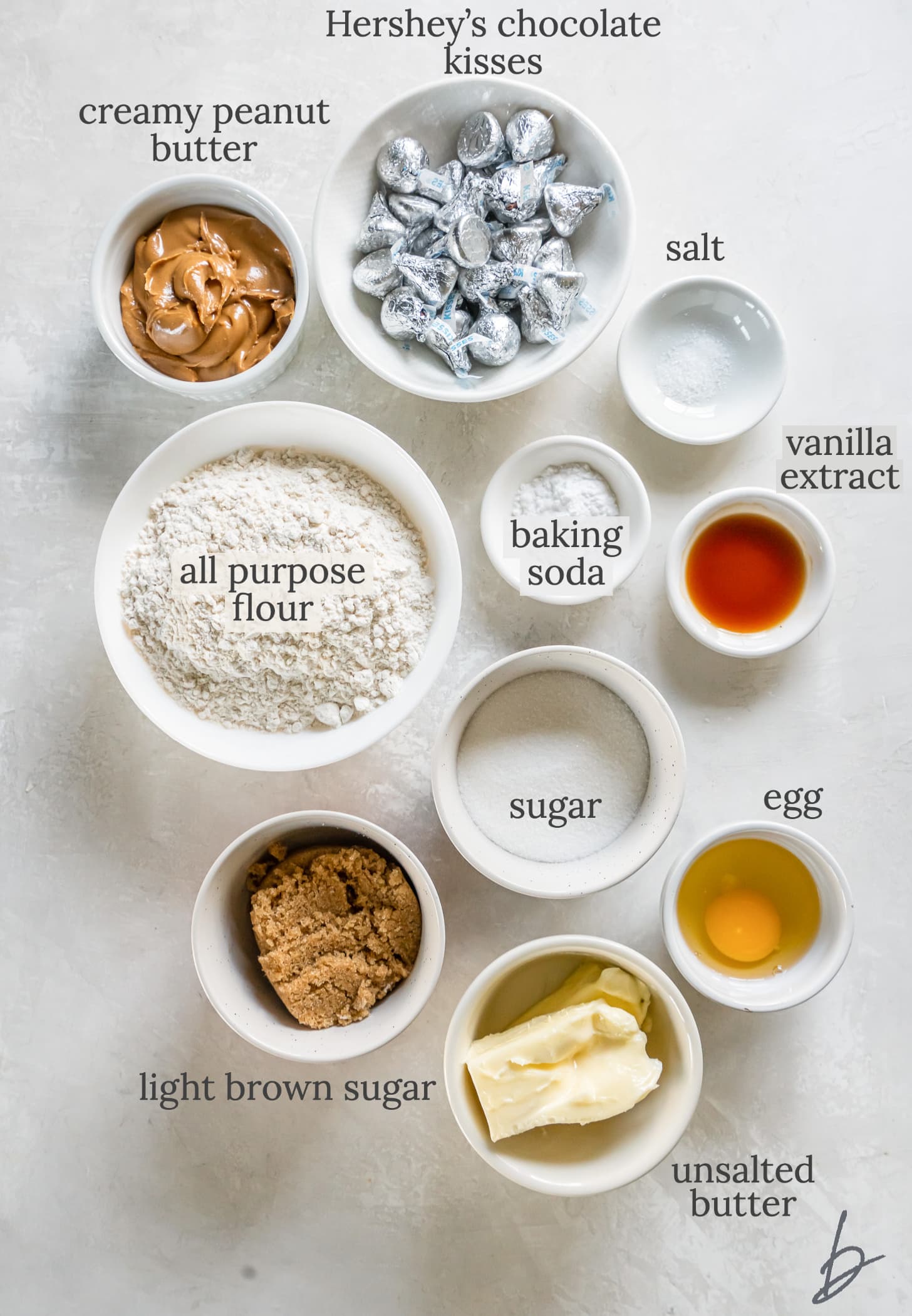 peanut butter blossoms ingredients in bowls labeled with text.