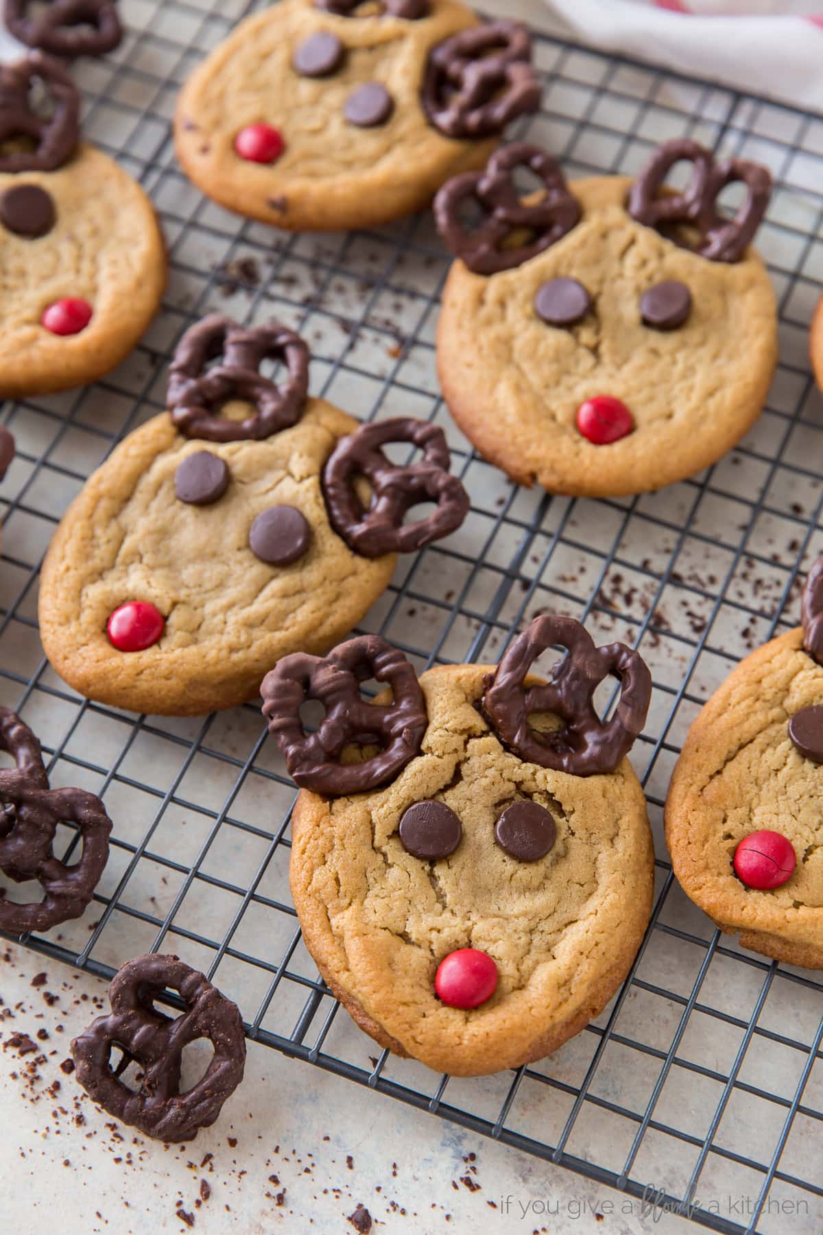 peanut butter reindeer cookies with pretzel antlers on wire cooling rack