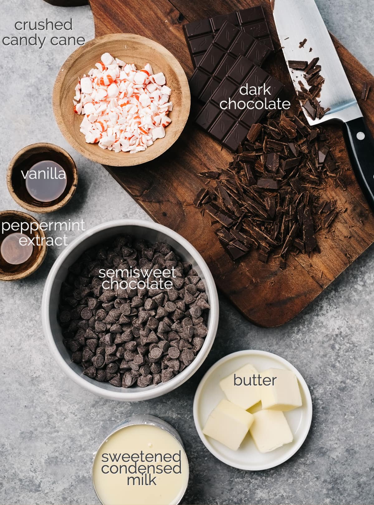 peppermint fudge ingredients in bowls labeled; dark chocolate on cutting board
