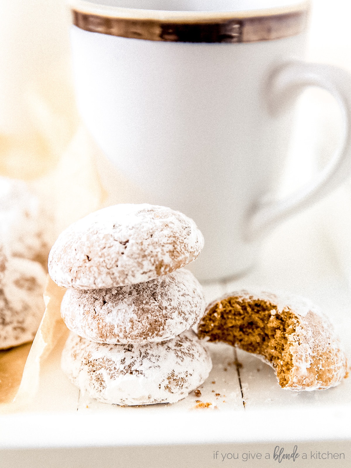 stack of pfeffernusse cookies on striped kitchen towels with anise stars