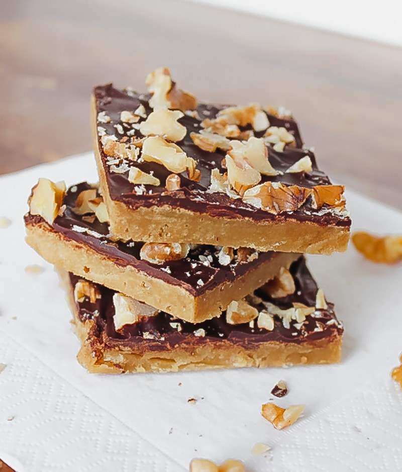 three toffee bars with chocolate stacked on top of each other