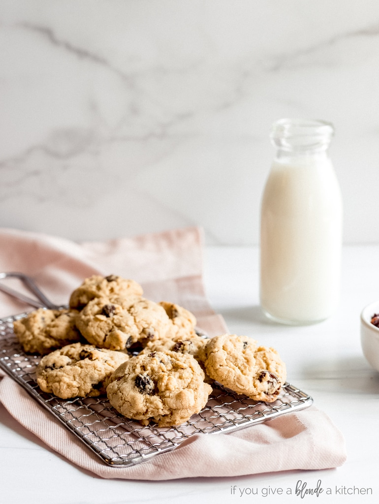 chewy oatmeal raisin cookies, pink kitchen cloth, glass milk bottle