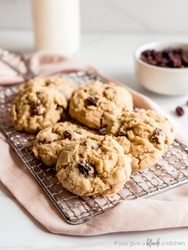 oatmeal raisin cookies on wire cooling rack and pink kitchen cloth