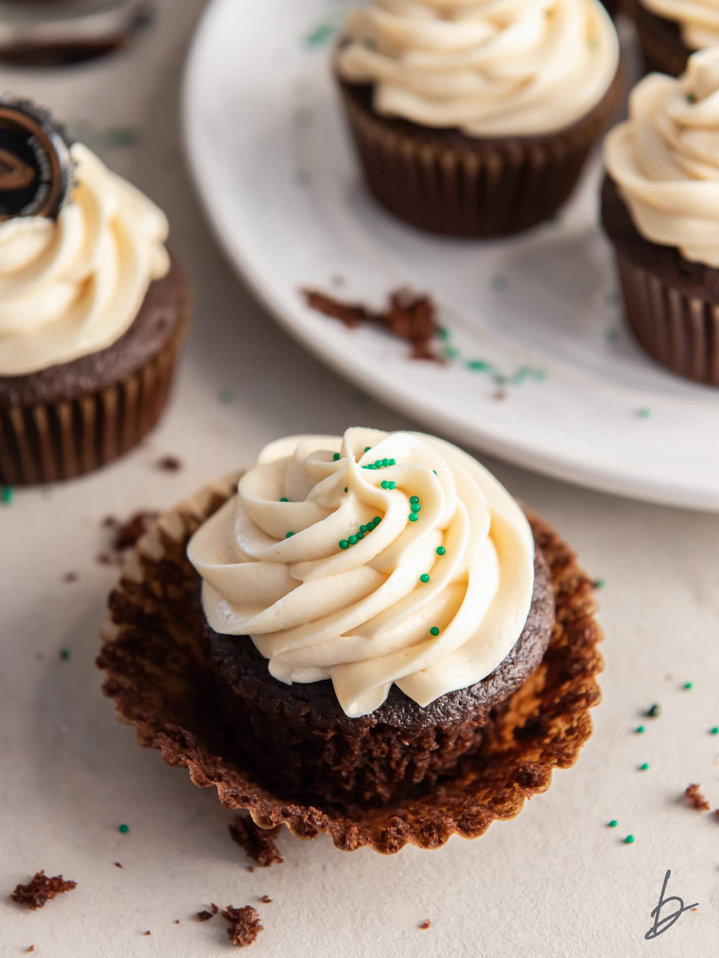 chocolate stout cupcake with irish cream frosting on paper cupcake liner.