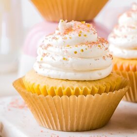 champagne cupcake with frosting and sprinkles