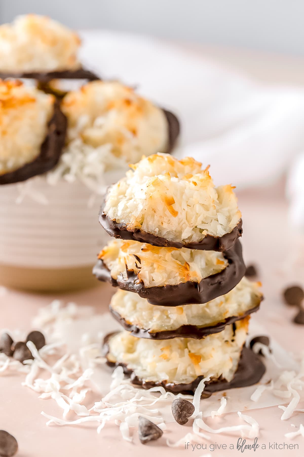 stack of four coconut macaroons with chocolate dipped bottoms