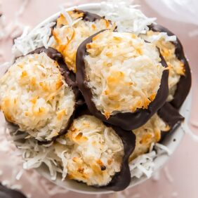 coconut macaroons piled in bowl with shredded coconut
