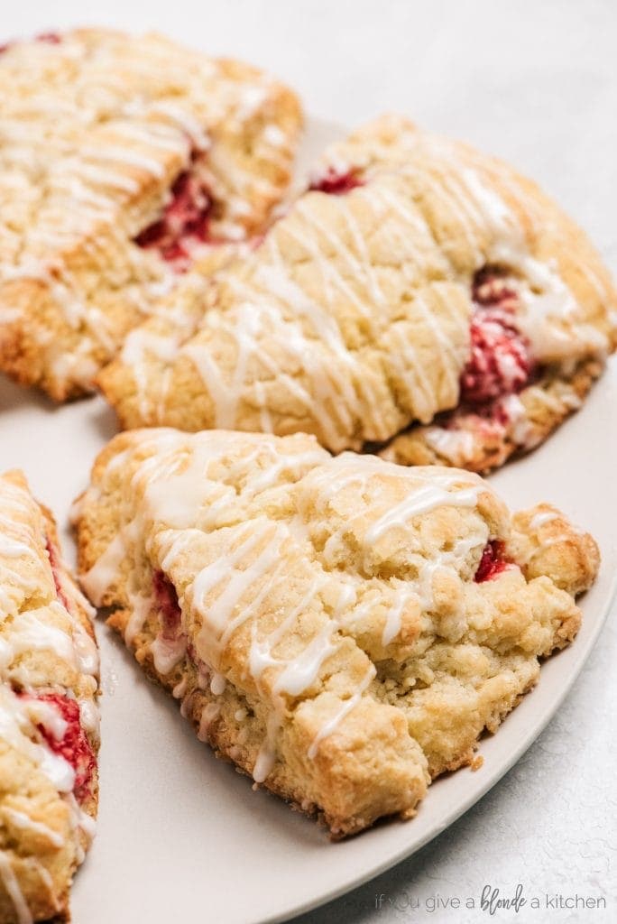 lemon raspberry scones with glaze on white plate