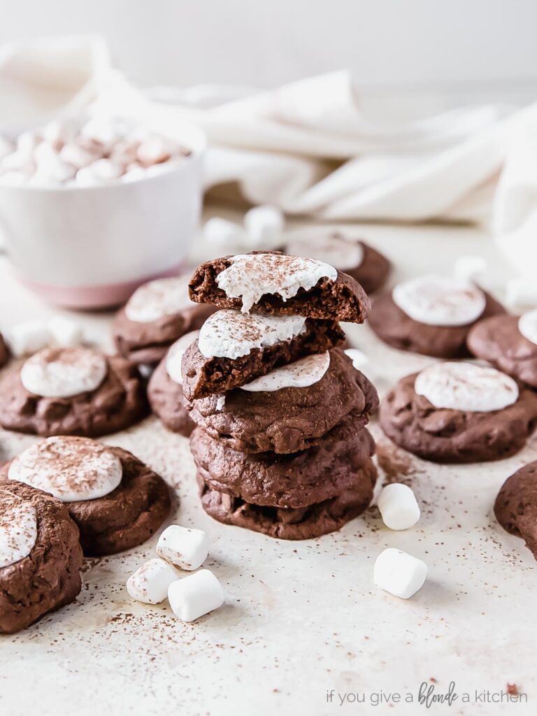 stack of hot cocoa cookies with marshmallows; top cookie in halves