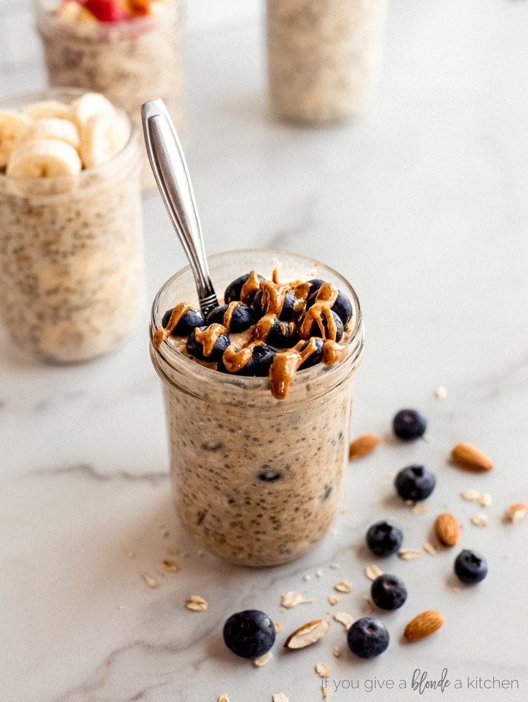 blueberries and almond butter on top of overnight oats jar