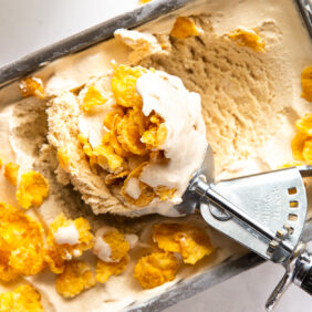 ice cream scoop in cereal milk ice cream with corn flakes
