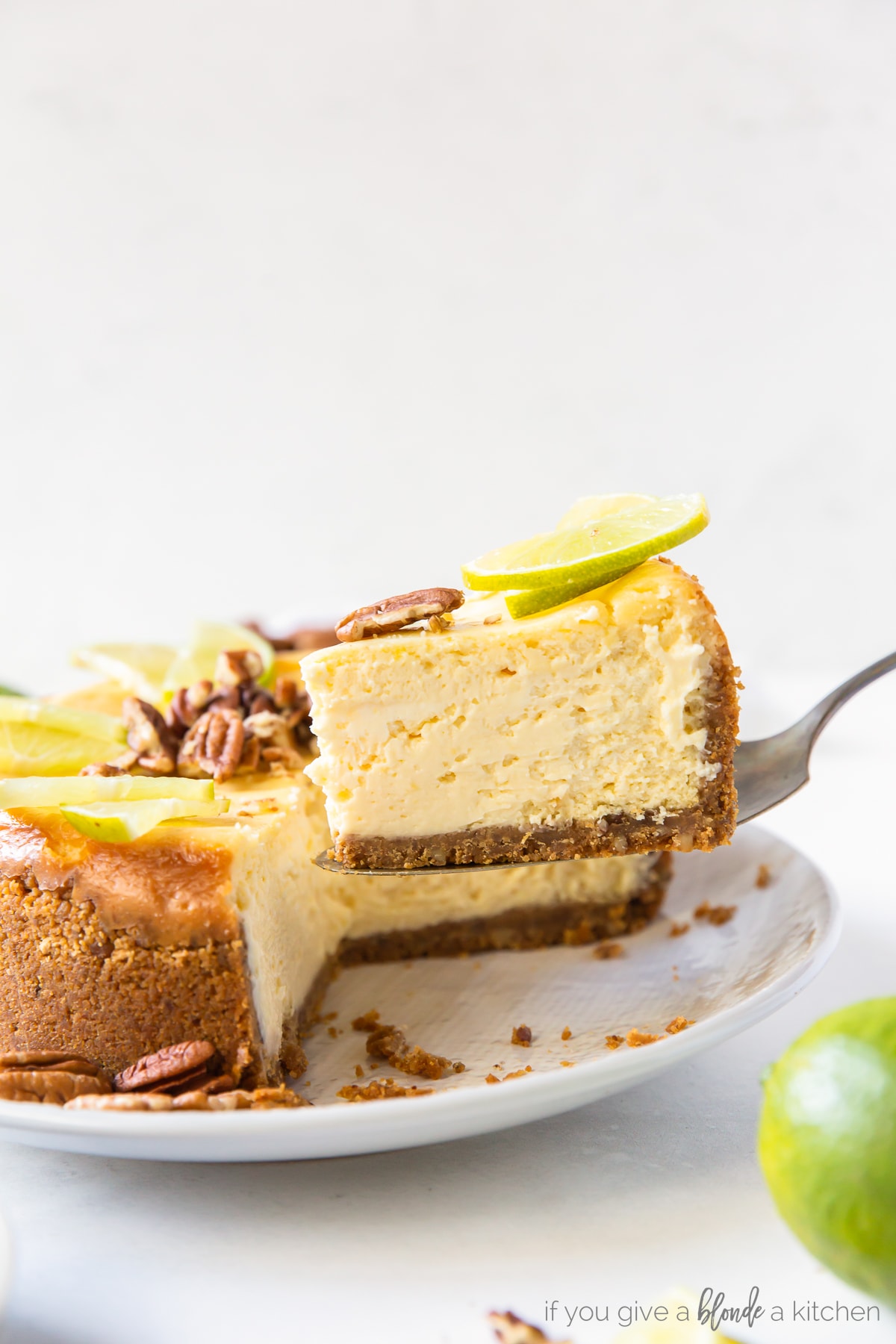 slice of lime curd cheesecake being lifted off of plate