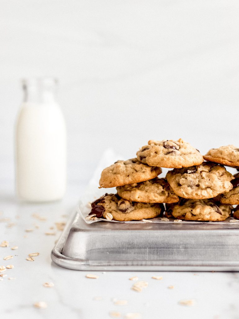 banana oatmeal cookies stacked on baking sheet