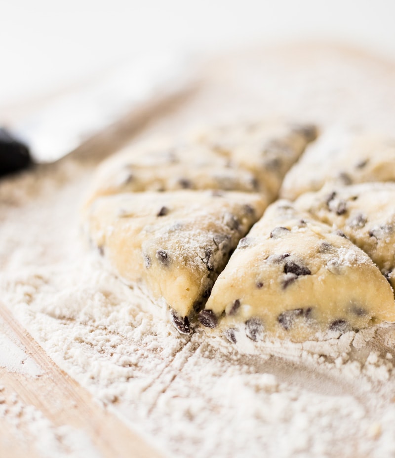 two bite chocolate chip mini scones cut into triangles and ready to bake