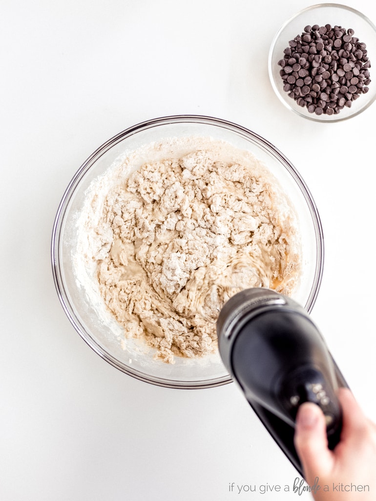 hand mixer combining flour with muffin batter