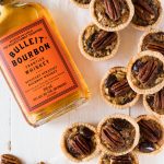 Mini Kentucky derby pies with bottle of Bulleit Bourbon