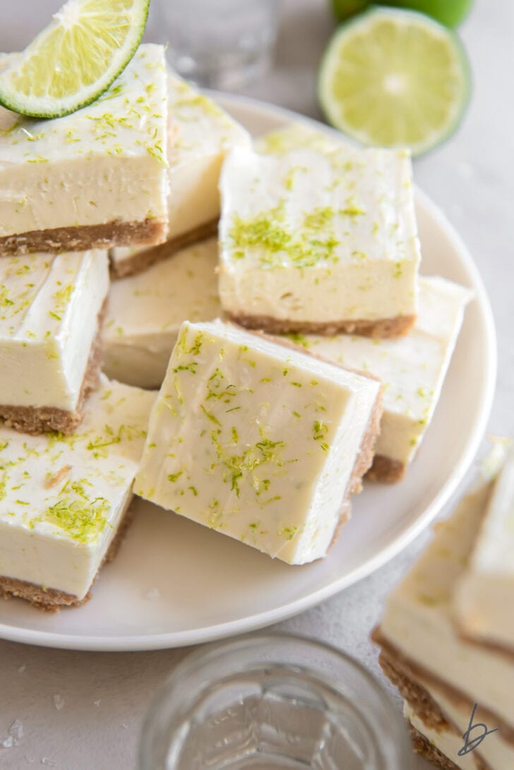 plate of no bake margarita cheesecake bars with lime zest