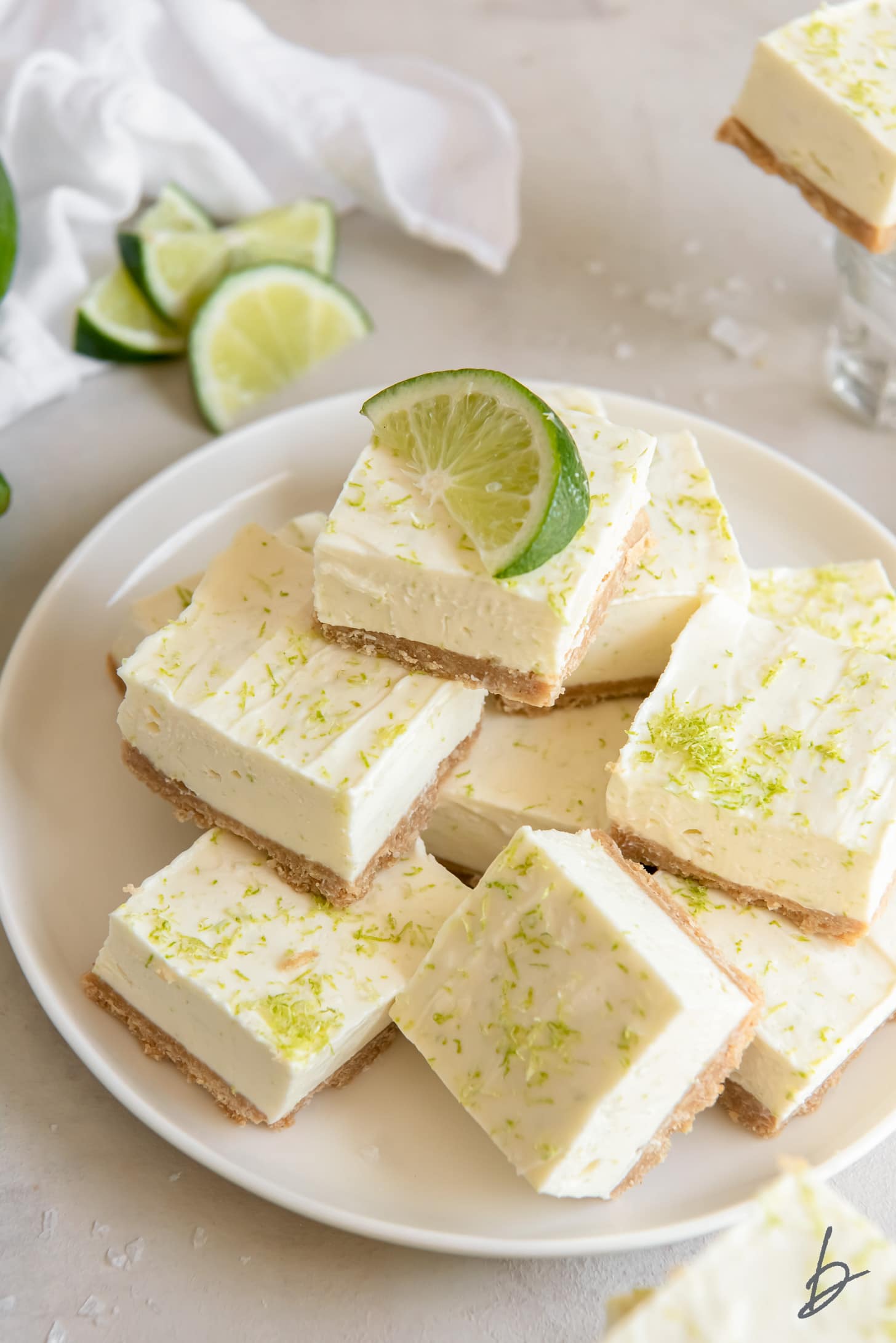 plate of no bake margarita cheesecake bars with lime zest