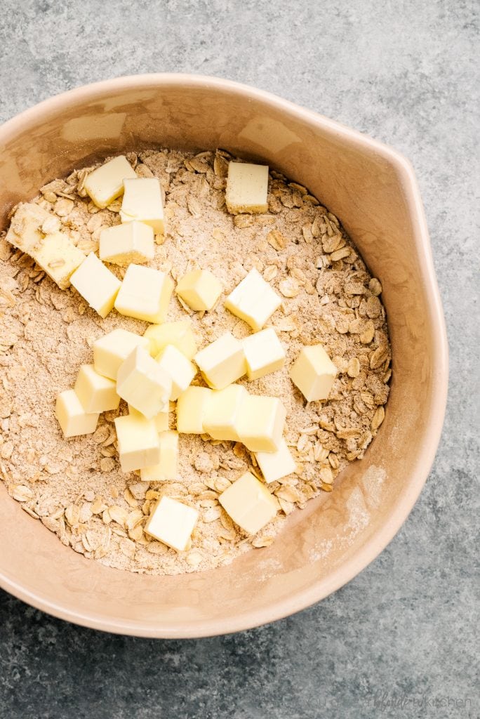 bowl of oats, sugar and cold butter cubes for crisp topping