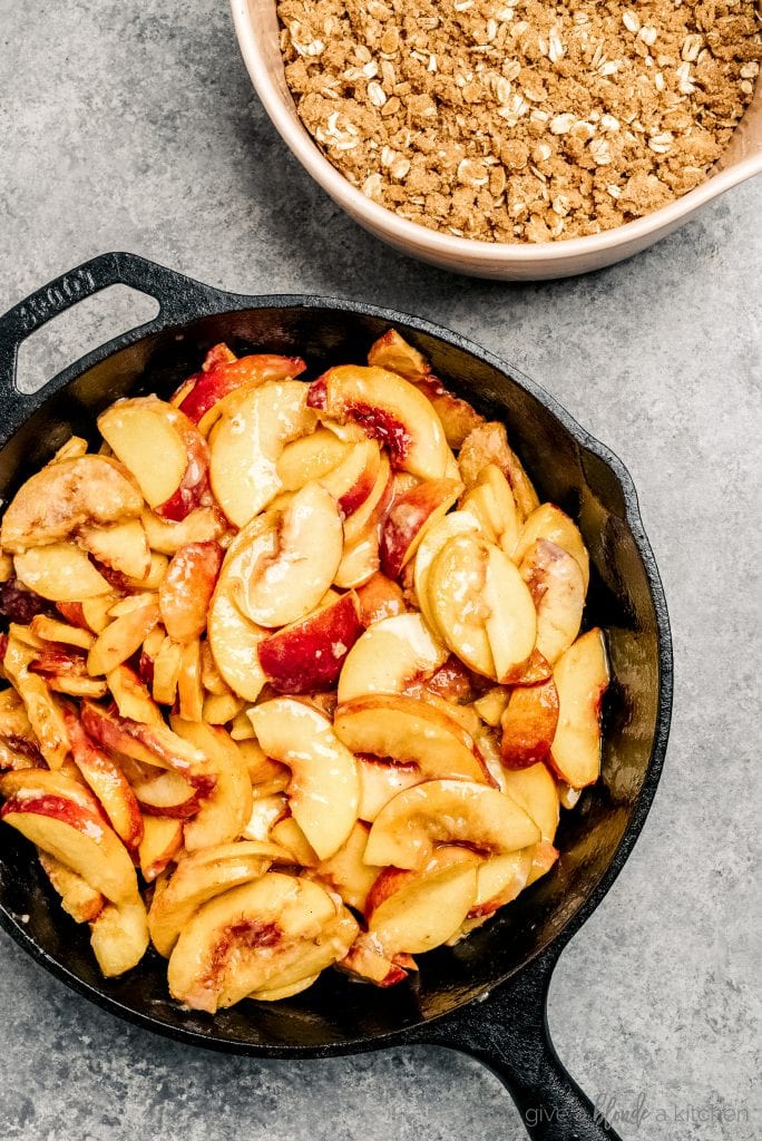 sliced peaches in cast iron skillet