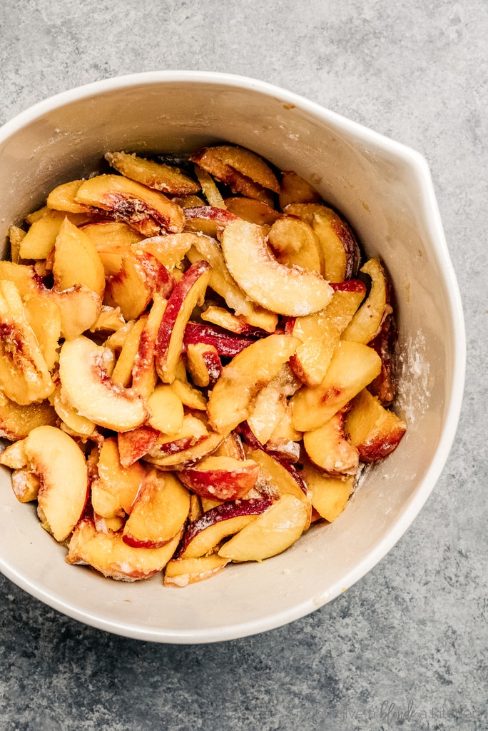 bowl of peach slices coated in sugar and flour