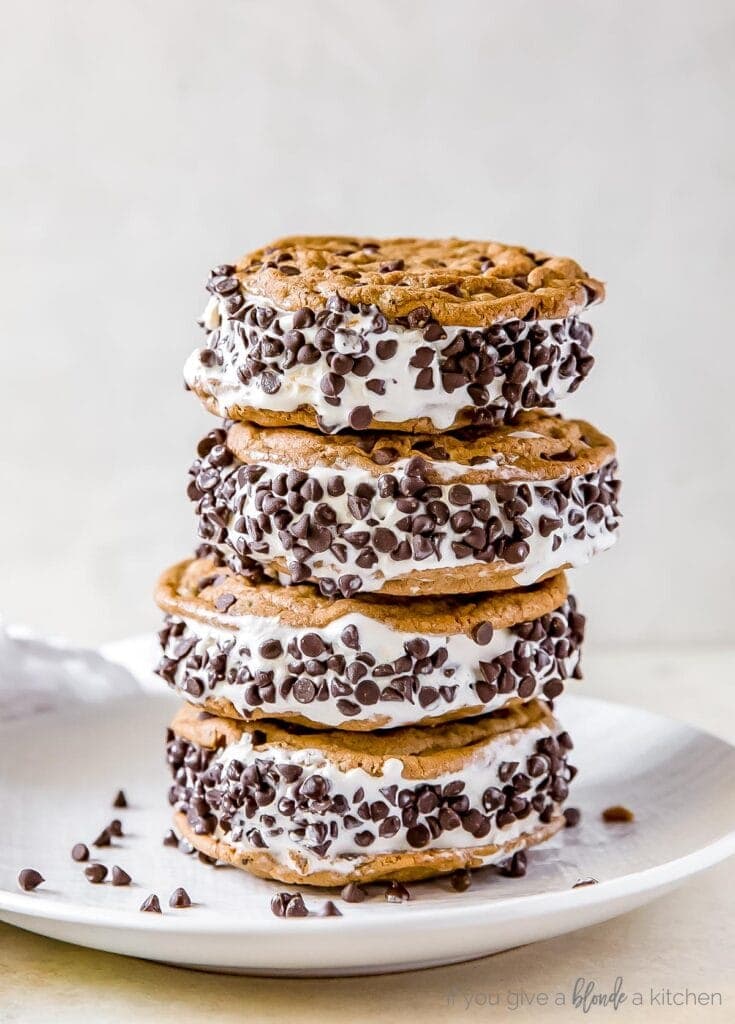 stack of four chocolate chip cookie ice cream sandwiches on white plate