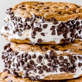 two chocolate chip cookie ice cream sandwiches stack on top of each other
