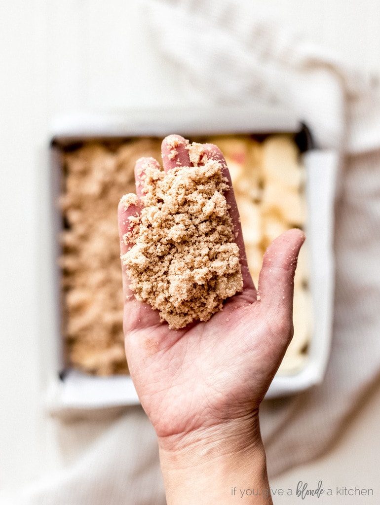 apple bars crumble topping in hand