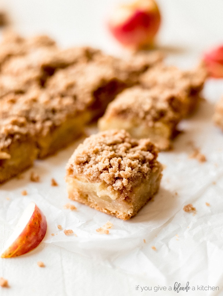 easy apple crisp bars square on parchment paper with apple slice