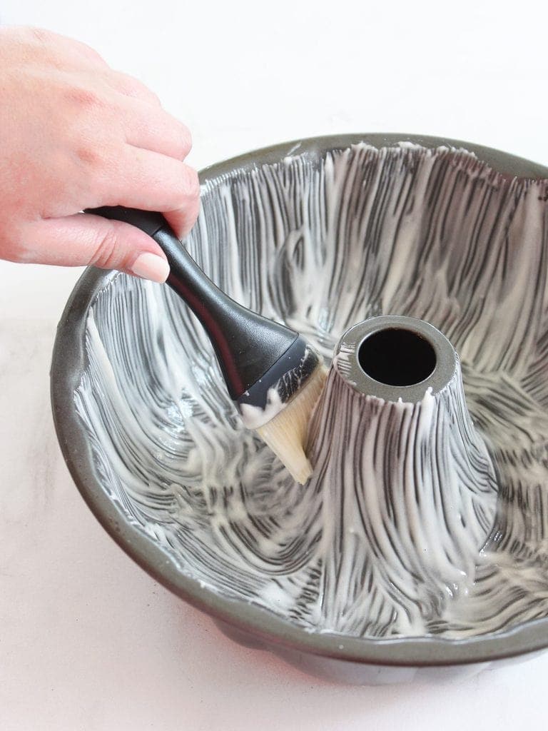 magic cake pan release on bundt cake with pastry brush