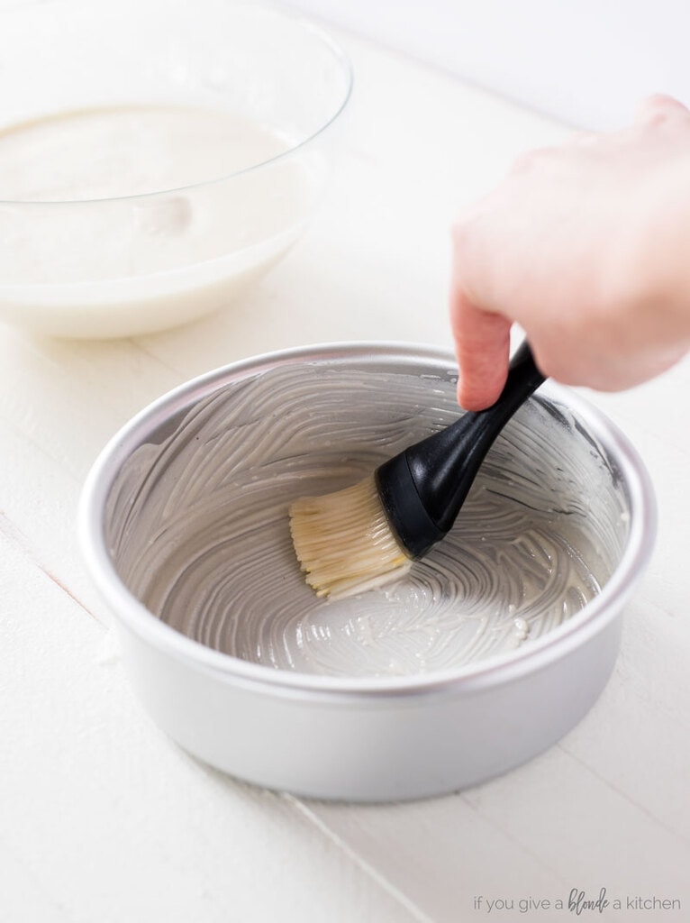 magic cake pan release paste. silver round cake pan with silicone pastry brush. homemade paste brushing inside of pan