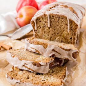 apple cider bread with cinnamon glaze and three slices cut off the loaf