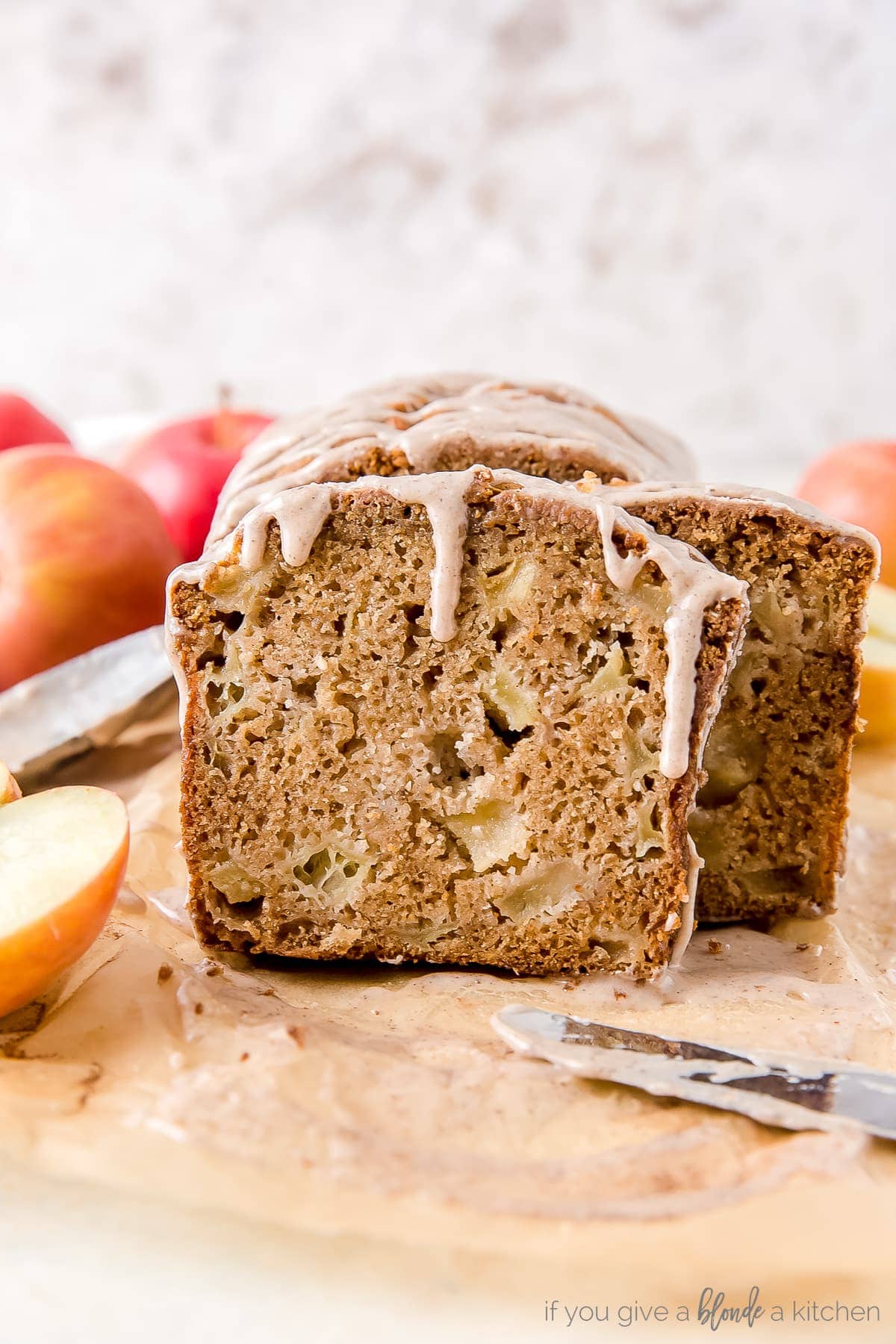 slice of apple cider bread with chunks of apples and glaze dripping down