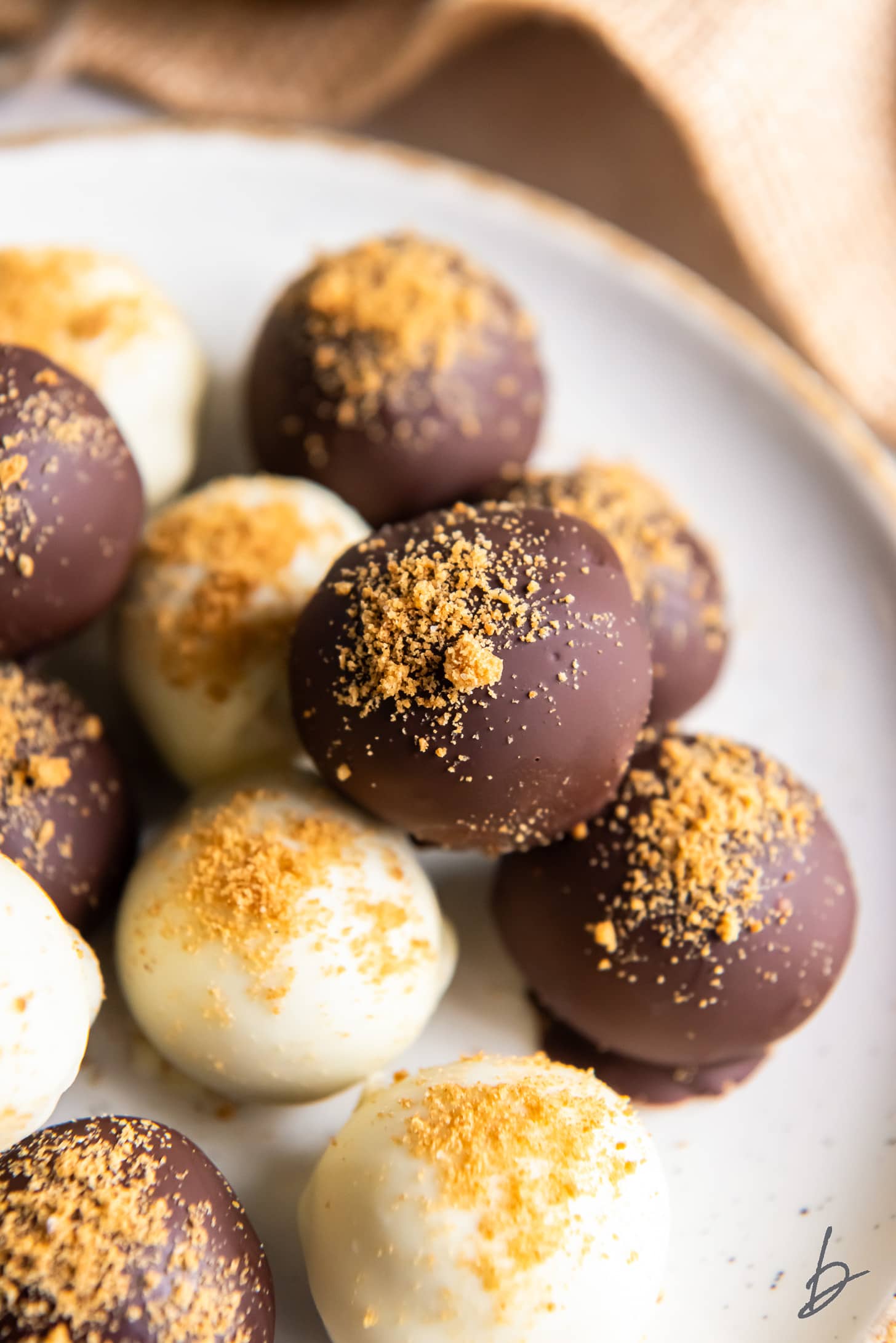 white chocolate and dark chocolate pumpkin truffles with sprinkle of crushed graham crackers.