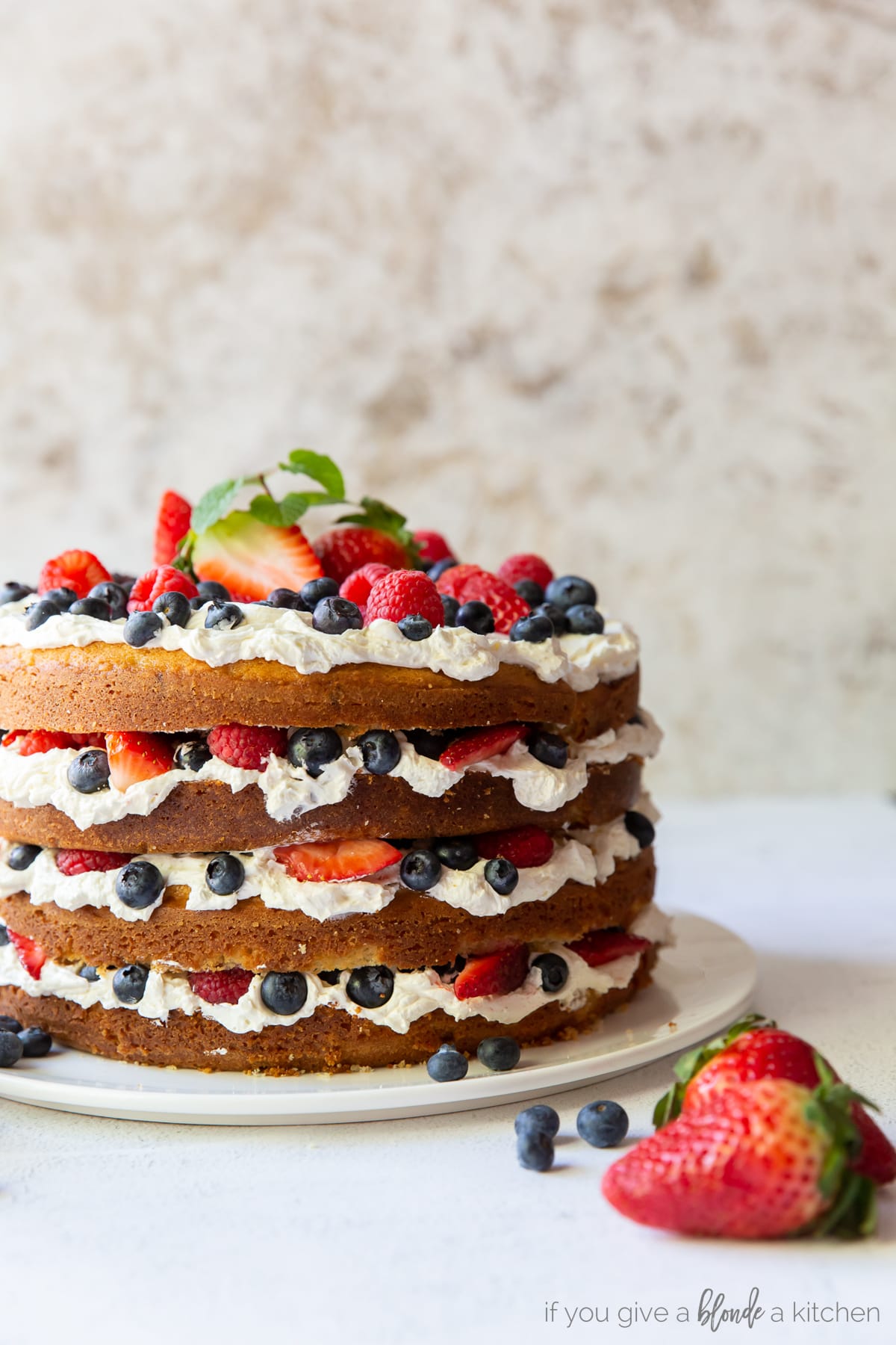 triple berry layer cake with swiss meringue buttercream and exposed layers