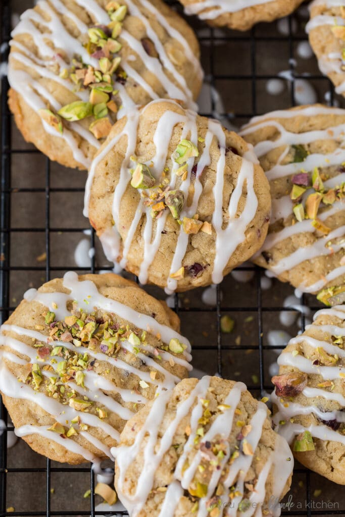 cranberry pistachio cookies with icing and chopped pistachios on top
