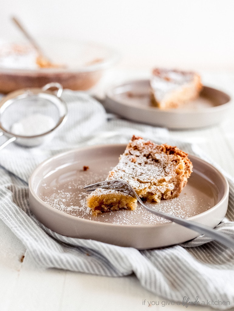 slice of milk bar pie on plate with fork taking bite