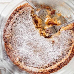 two forks in a pie dish with momofuku crack pie dusted with confectioners sugar