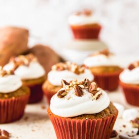 sweet potato cupcake topped with marshmallow frosting and chopped pecans