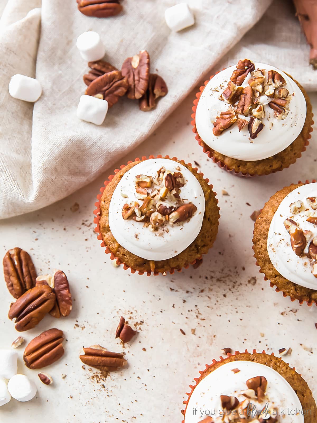 sweet potato cupcakes with marshmallow creme frosting and chopped pecans