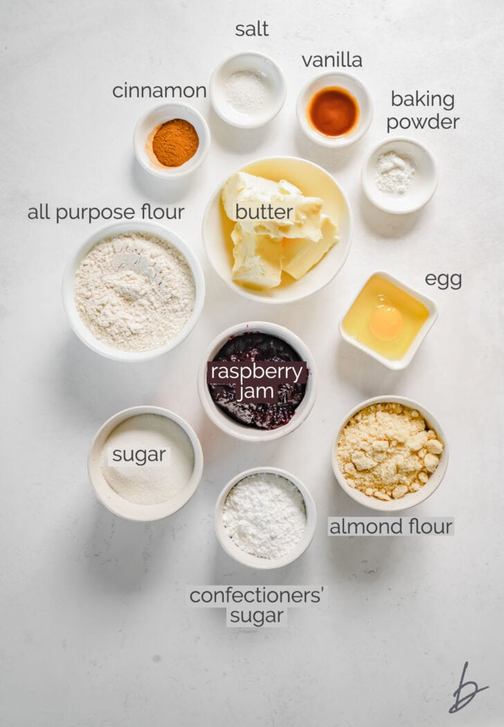 linzer cookies ingredients in bowls labeled with text